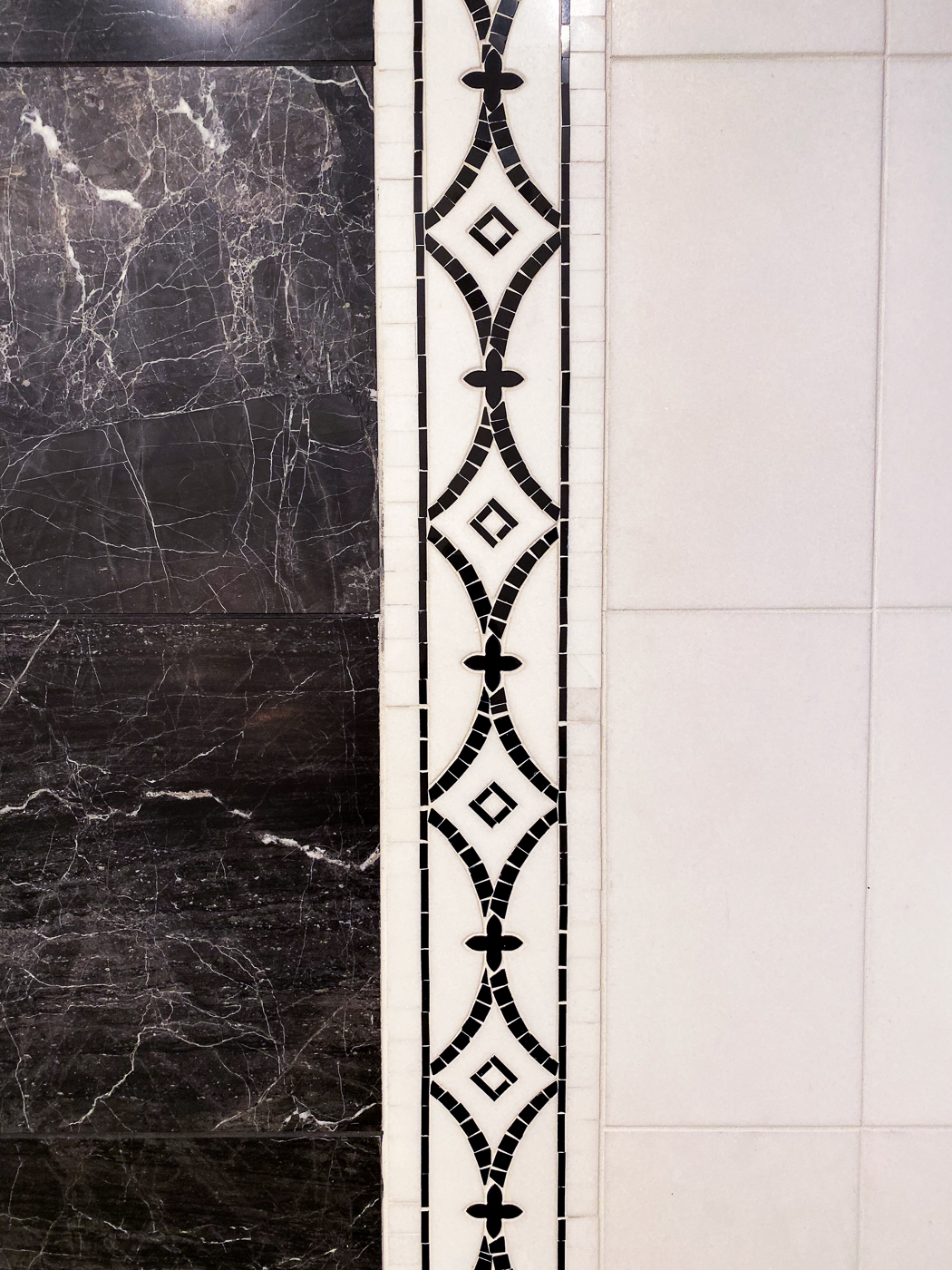 Detail photo of black & white custom tile floor in master bathroom
