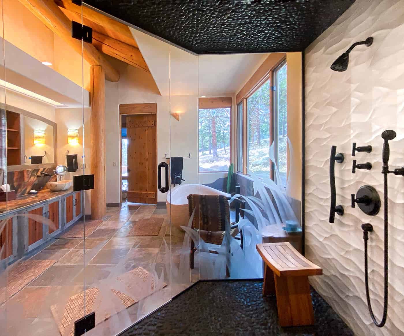 Walk-in shower with pebble floor and ceiling and curved tile walls